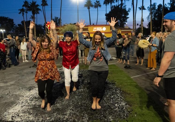 Multiple people participating in the Annual Arizona Firewalking Ceremony